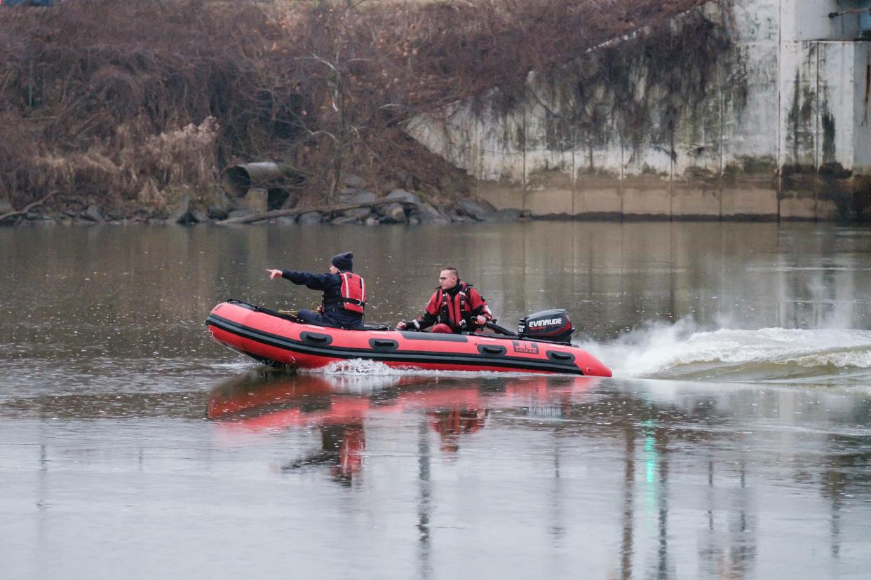 New Philadelphia Fire Department dive team members respond Tuesday to a call for a reported body in the Tuscarawas River near Buehler's Fresh Foods. All that was found were blobs of river foam. The scene was eventually cleared after the dive team made several passes up and down river.