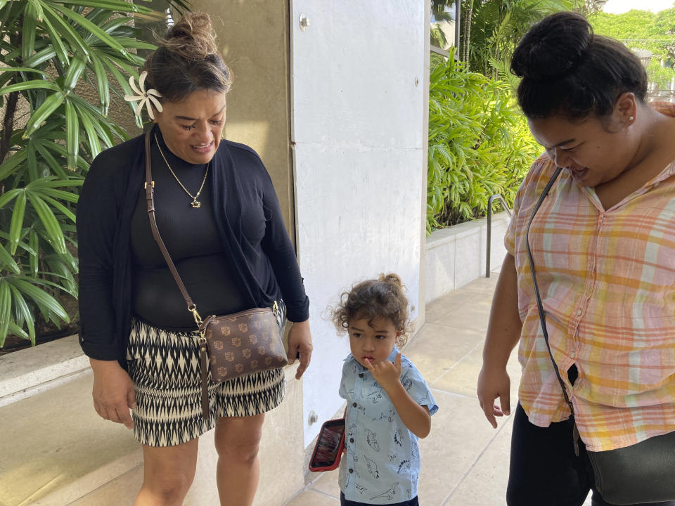 Kaulana Alo-Kaonohi's mother, Maipela Kaonohi, left, his son, center, and his sister Kawehilani Alo-Kaonohi are shown outside U.S. District Court in Honolulu on Thursday, Nov. 17, 2022, after Alo-Kaonohi, who is Native Hawaiian, was found guilty of a hate crime in the 2014 beating of a white man. U.S. District Judge J. Michael Seabright ordered Alo-Kaonohi and Levi Aki Jr. detained pending sentencing scheduled for March 2, 2023. (AP Photo/Jennifer Sinco Kelleher)