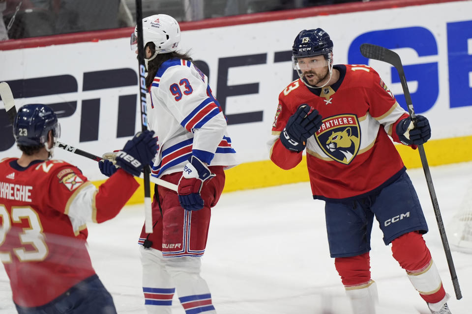 Florida Panthers centers Sam Reinhart (13) celebrates with Carter Verhaeghe (23) after Reinhart scored in the first period of Game 3 during the Eastern Conference finals of the NHL hockey Stanley Cup playoffs against the New York Rangers, Sunday, May 26, 2024, in Sunrise, Fla. (AP Photo/Wilfredo Lee)