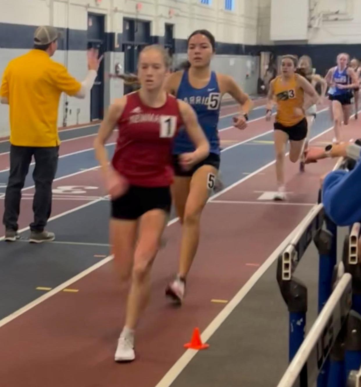 Winnacunnet senior Charlotte Koutalidis trails Newmarket's Alison Hagen in Saturday's 1,000-meter race at an open qualifier meet at the University of New Hampshire. Koutalidis set a Winnacunnet school record with a time of 3 minutes, 03.35 seconds.