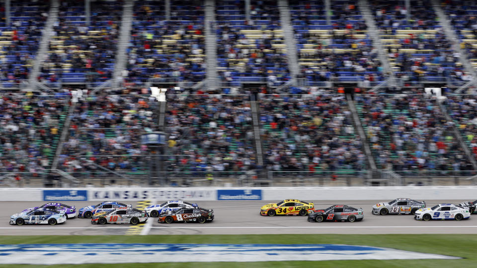 Racers head toward Turn 1 at the start of a NASCAR Cup Series auto race at Kansas Speedway in Kansas City, Kan., Sunday, May 5, 2024. (AP Photo/Colin E. Braley)