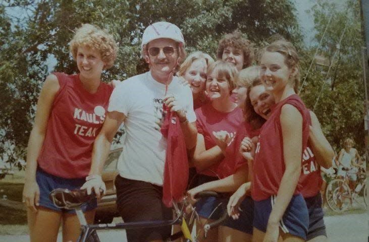 Donald Kaul, second from left, is seen in this undated photo with a custom bike, which will be auctioned off at Saturday's RAGBRAI route announcement party.