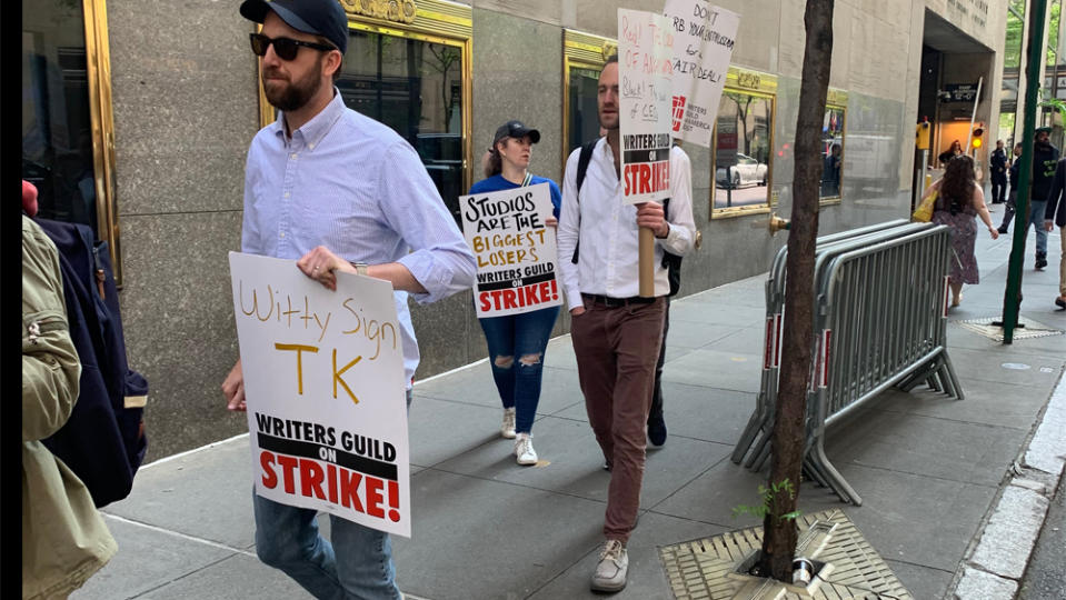 ‘The Daily Show’s Jordan Klepper, left, walks the WGA picket line in New York. (Sean Piccoli/Deadline)