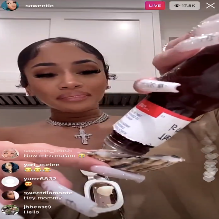 Saweetie putting sauce on her oysters