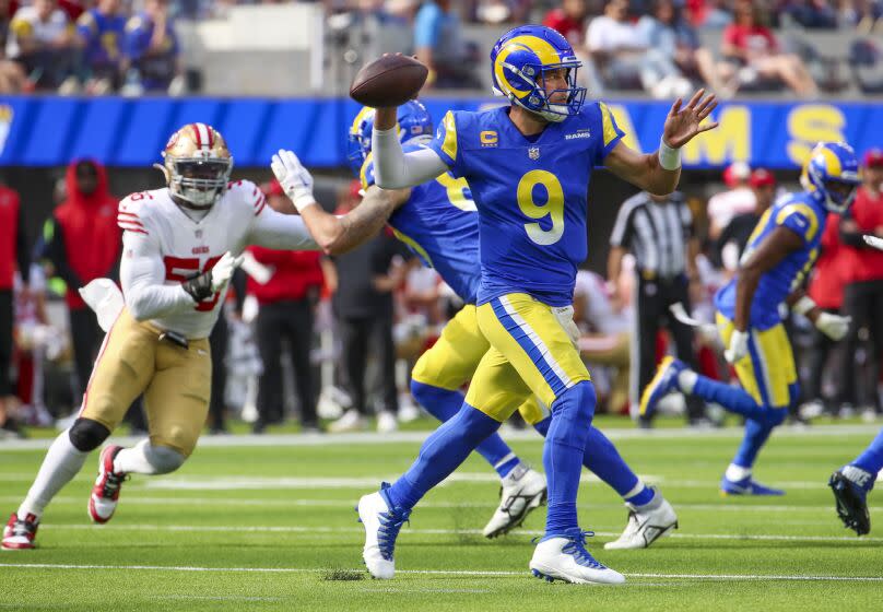 Inglewood, CA - October 30: Rams quarterback Matthew Stafford throws the ball under pressure from the 49ers defense.
