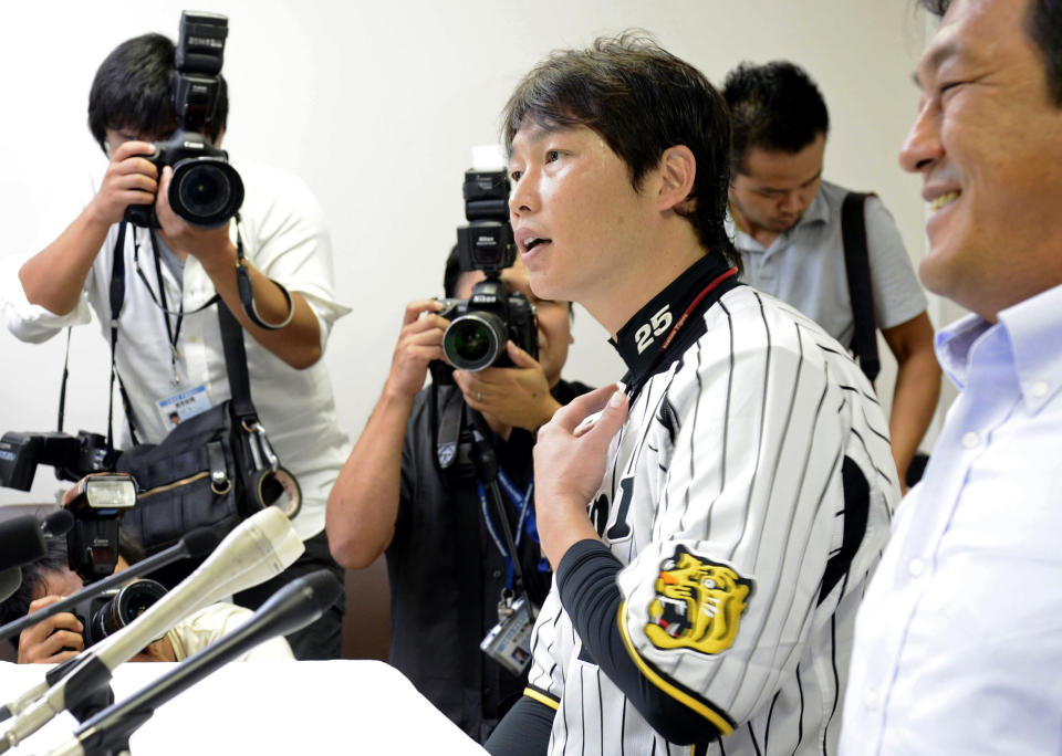 The Japan Professional Baseball Players Association Chairman Takahiro Arai speaks during a news conference in Nishinomiya, Japan, Tuesday, Sept. 4, 2012. The association agreed to take part in the 2013 World Baseball Classic Tuesday, backing off from a threat to boycott the event over the way tournament revenue is shared. (AP Photo/Kyodo News) JAPAN OUT, MANDATORY CREDIT, NO LICENSING IN CHINA, HONG KONG, JAPAN, SOUTH KOREA AND FRANCE