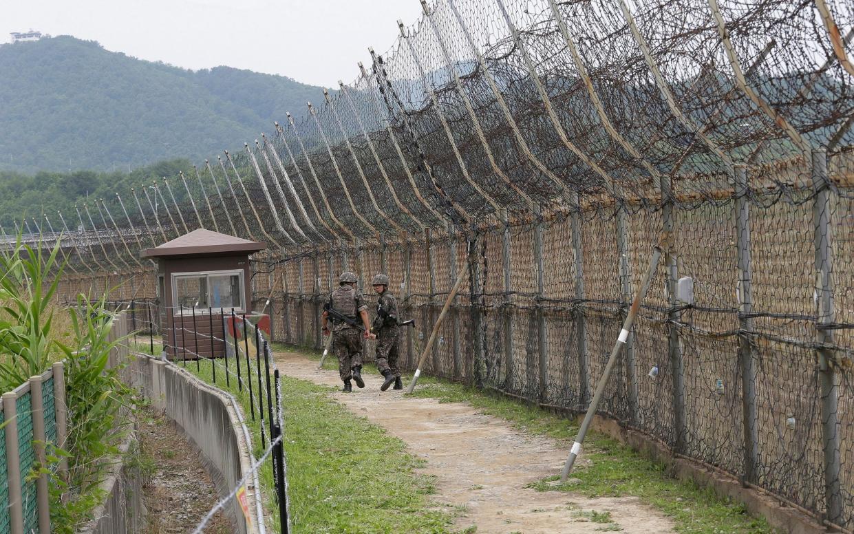 Kim Woo Joo used his gymnastic skills to climb a 10-foot barbed wire fence on the DMZ’s southern perimeter - AP