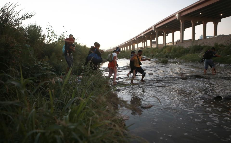 Venezuelan migrants walk from Ciudad Juarez, Mexico, on Oct. 13, 2022, across the Rio Bravo toward the U.S. border to surrender to patrol officers.