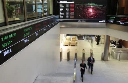 People walk through the lobby of the London Stock Exchange in London, Britain November 30, 2015. REUTERS/Suzanne Plunkett