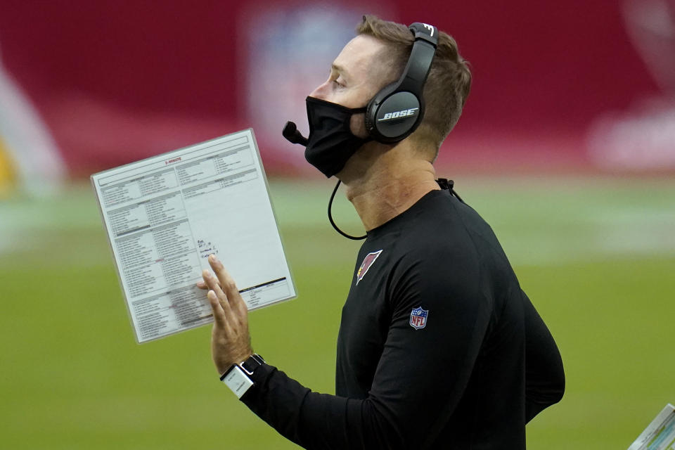 Arizona Cardinals head coach Kliff Kingsbury makes a call during the second half of an NFL football game against the Washington Football Team, Sunday, Sept. 20, 2020, in Glendale, Ariz. (AP Photo/Ross D. Franklin)