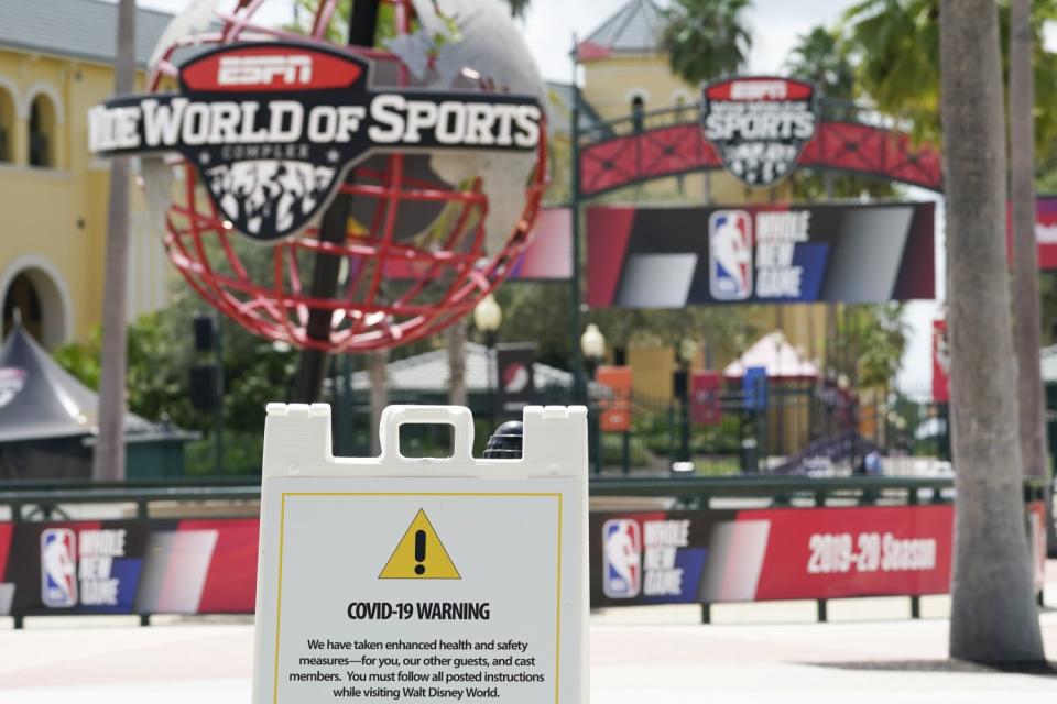 A COVID-19 warning is posted outside basketball arenas at ESPN Wide World of Sports Complex before the NBA restart