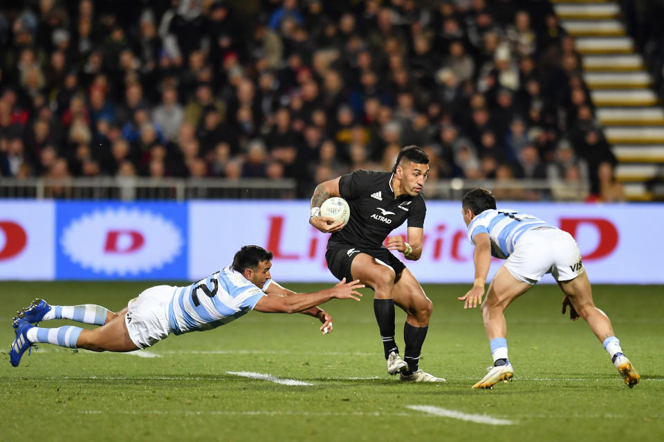 Rieko Ioane of New Zealand, right, is tackled by Argentina's Matias Orlando, left, and Matias Moroni during their Rugby Championship test match in Christchurch, New Zealand, Saturday, Aug. 27, 2022. (John Davidson/Photosport via AP)