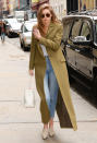 <p>Hadid was spotted in New York City wearing a long olive topper that gave us serious coat envy. She paired the chic piece with a white top, cropped Sandro jeans, neutral Nicholas Kirkwood slides, a fresh white bucket bag, and oversize Sunday Somewhere round sunnies.</p>