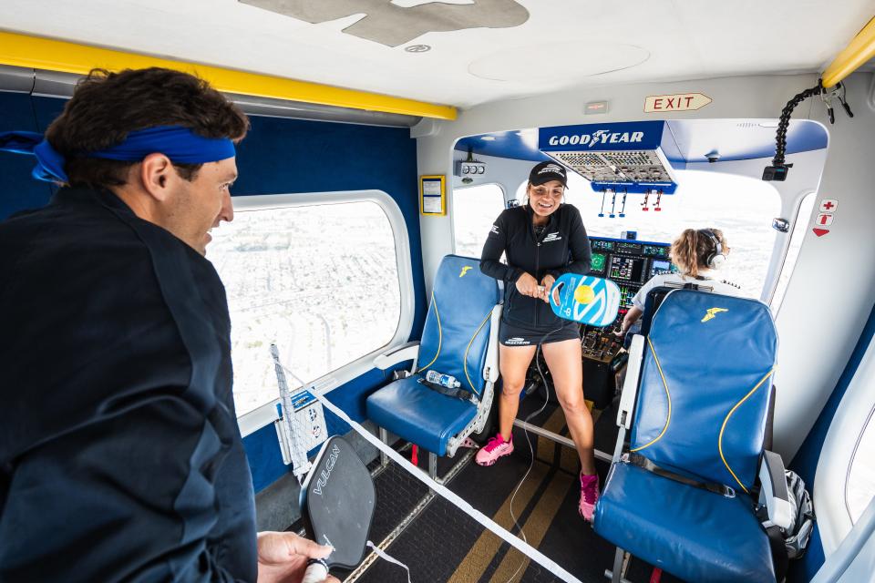 Catherine Parenteau and Jay Devilliers engage in pickleball volleys on a makeshift court aboard the Goodyear Blimp.