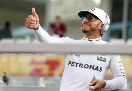 Formula One - F1 - Abu Dhabi Grand Prix - Yas Marina Circuit, Abu Dhabi, United Arab Emirates - 27/11/2016 - Mercedes' Formula One driver, Lewis Hamilton of Britain gives thumbs up at his fans during driver's parade. REUTERS/Hamad I Mohammed