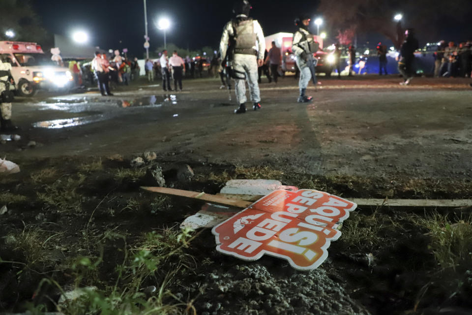 Electoral signs lay on the ground as security forces secure the area after a stage collapsed due to a gust of wind during an event attended by presidential candidate Jorge Álvarez Máynez in San Pedro Garza García, on the outskirts of Monterrey, Mexico, Wednesday, May 22, 2024. President Andres Manuel Lopez Obrador confirmed that four people were killed and at least a dozen injured. (AP Photo/Alberto Lopez)