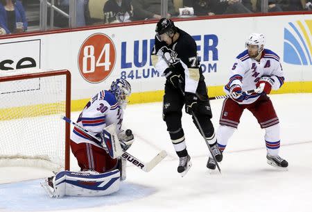 May 9, 2014; Pittsburgh, PA, USA; New York Rangers goalie Henrik Lundqvist (30) makes a glove save as Pittsburgh Penguins center Evgeni Malkin (71) attempts a screen and New York defenseman Dan Girardi (5) defends during the third period in game five of the second round of the 2014 Stanley Cup Playoffs at the CONSOL Energy Center. The Rangers won 5-1. Mandatory Credit: Charles LeClaire-USA TODAY Sports