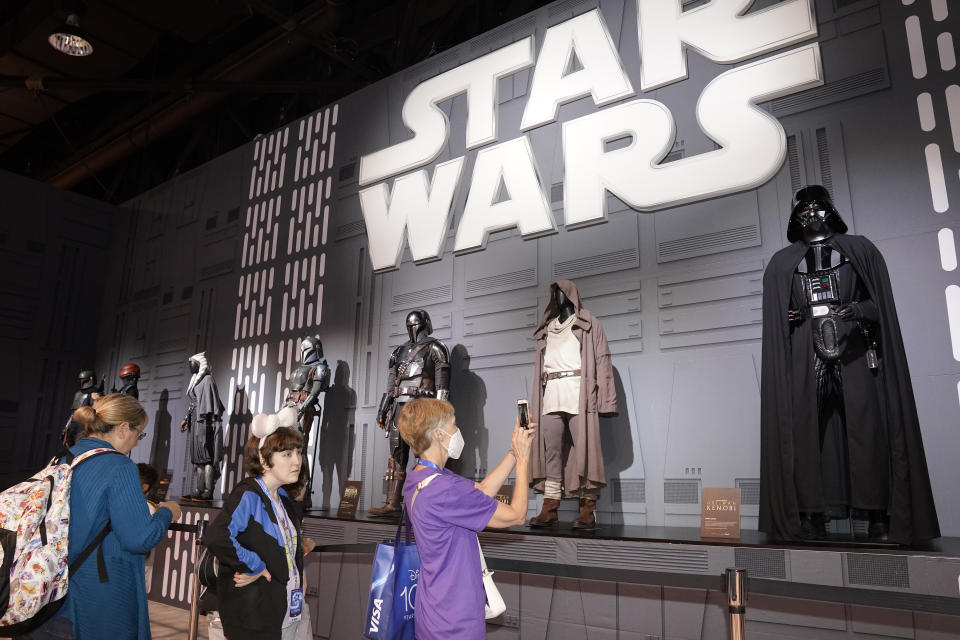 Fans look at Star Wars costumes at the D23 Expo Saturday, Sept. 10, 2022, in Anaheim, Calif. (AP Photo/Mark J. Terrill)