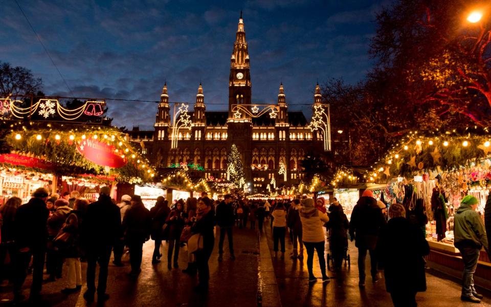 Christmas lights decorate the market and the City Hall in Vienna, Austria - AFP/JOE KLAMAR