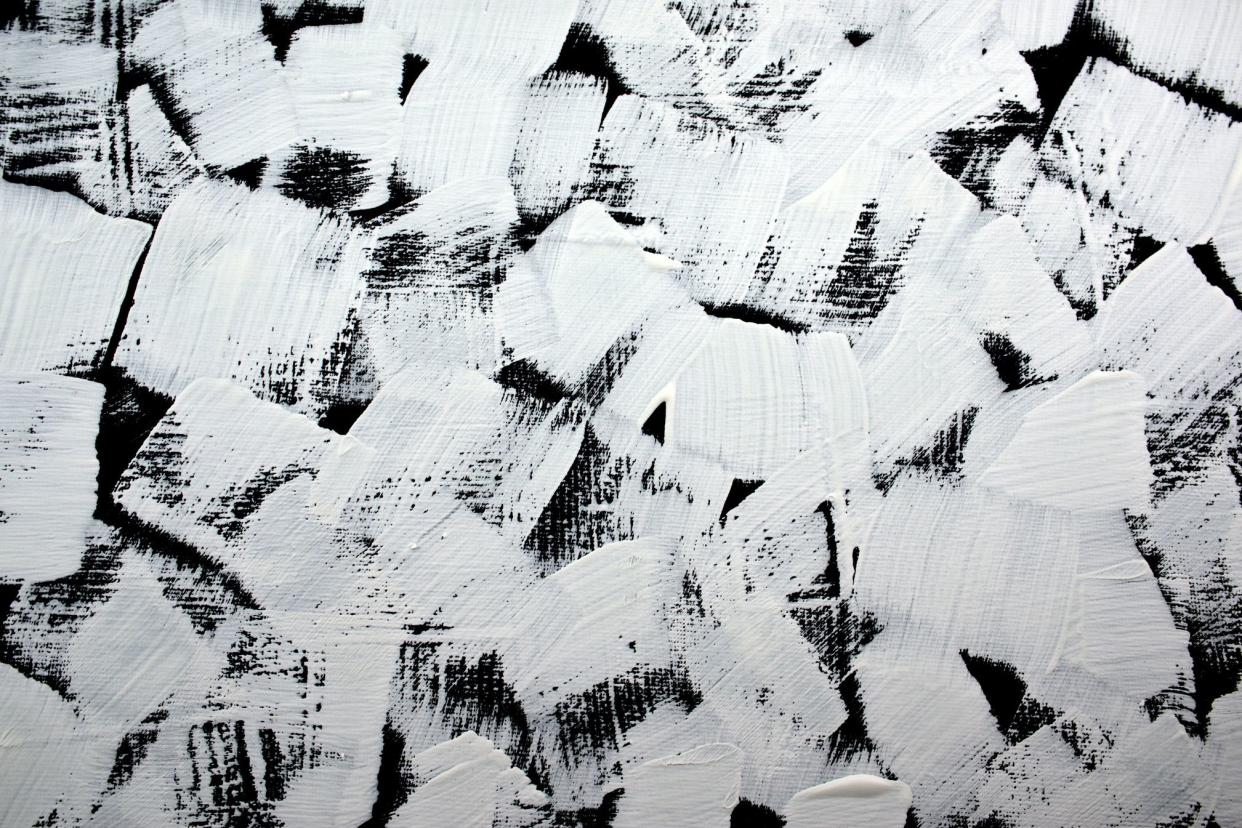 Closeup of an abstract painting, white brush strokes on a black background, on canvas