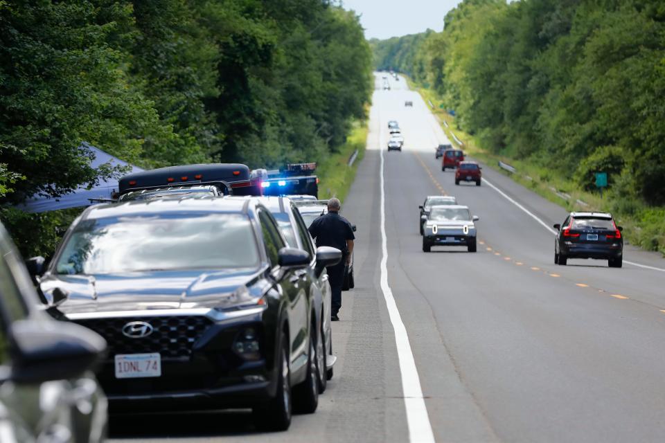 Federal and state investigators search for evidence in the wooded area adjacent to Route 88 northbound in Westport.