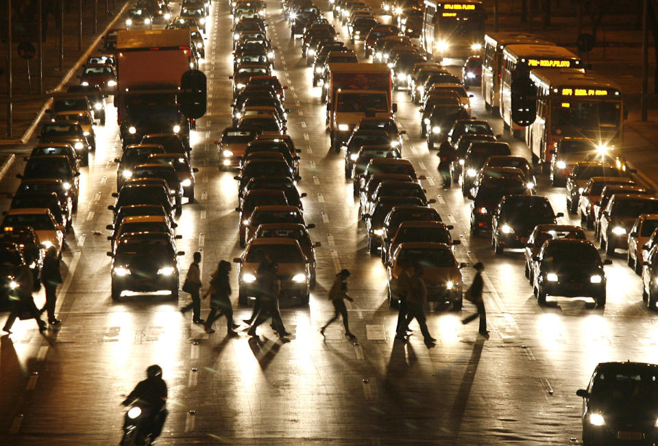 FILE - Cars stop for pedestrians crossing a major avenue in Brasilia, Brazil, Thursday, July 10, 2008. Brazil's finance ministry has announced a series of measures to boost domestic consumption: targeted tax cuts on Brazil-made products, interest rate reductions and an extension in the time allowed to pay back loans. The measures will make local cars about 10 percent cheaper, and reduce taxes on financial transactions. (AP Photo/Eraldo Peres, File)