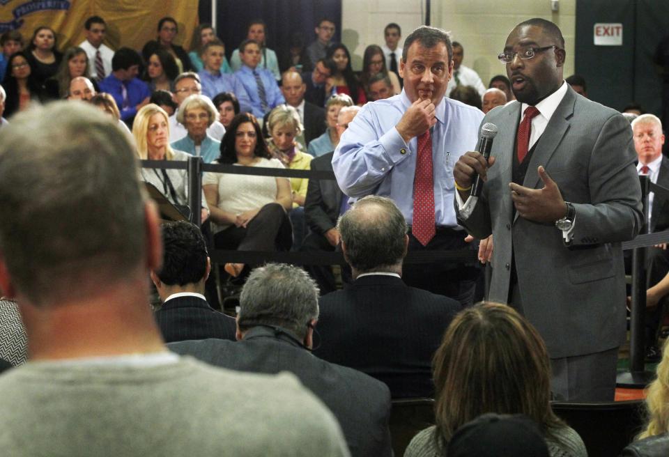 New Jersey Gov. Chris Christie center left, listens as Richard E. Constable, III, right, Commissioner New Jersey Department of Community Affairs answers a Superstorm Sandy-related question during a town hall meeting in Brick Township, N.J., Thursday, April 24, 2014. (AP Photo/Mel Evans)