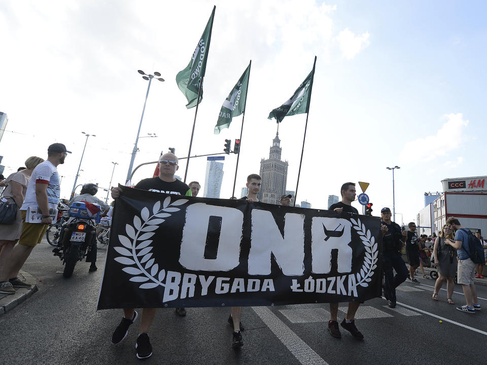 Supporters of the far-right National-Radical Camp, ONR, take part in the commemoration of the 74th anniversary of the 1944 Warsaw Uprising at a street in the city center in downtown Warsaw, Poland, Wednesday, Aug. 1, 2018. (AP Photo/Czarek Sokolowski)