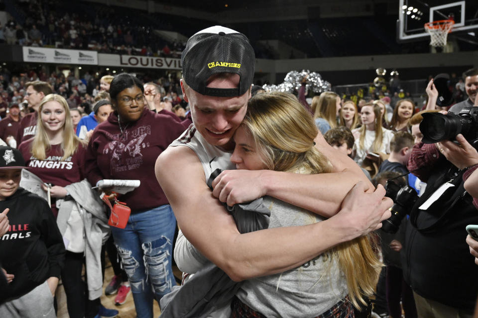 Bellarmine guard CJ Fleming hugs his fiancee, Lexy Hoffman, after Bellarmine's 77-72 victory over Jacksonville in an NCAA college basketball game for the championship in the Atlantic Sun Conference tournament Louisville, Ky., Tuesday, March 8, 2022. (AP Photo/Timothy D. Easley)