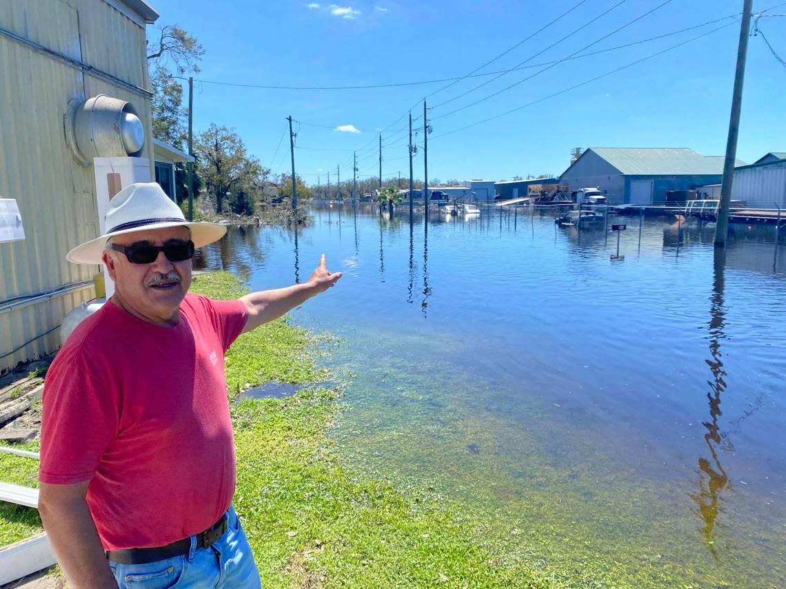 In Arcadia, Enrique Sánchez points to an area flooded by the rising waters of the Peace River on Sept. 30, 2022. The rural areas of Southwest Florida were hit hard by rains from Hurricane Ian.