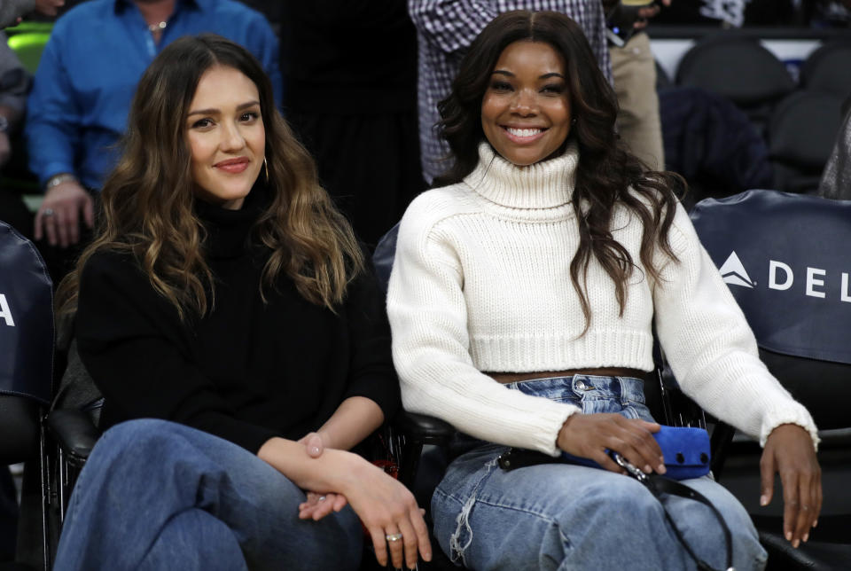 FILE - This Dec. 10, 2018 file photo shows actresses Jessica Alba, left, and Gabrielle Union at an NBA basketball game between the Los Angeles Lakers and the Miami Heat in Los Angeles. Union and Alba star in "L.A.'s Finest," a spin off Union's character from "Bad Boys II." (AP Photo/Marcio Jose Sanchez, File)