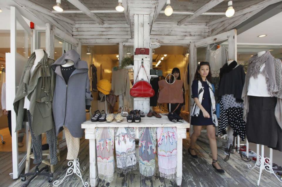 Women walk out of a shop on the Garosugil or the Tree-Lined Street in the Gangnam area of Seoul.