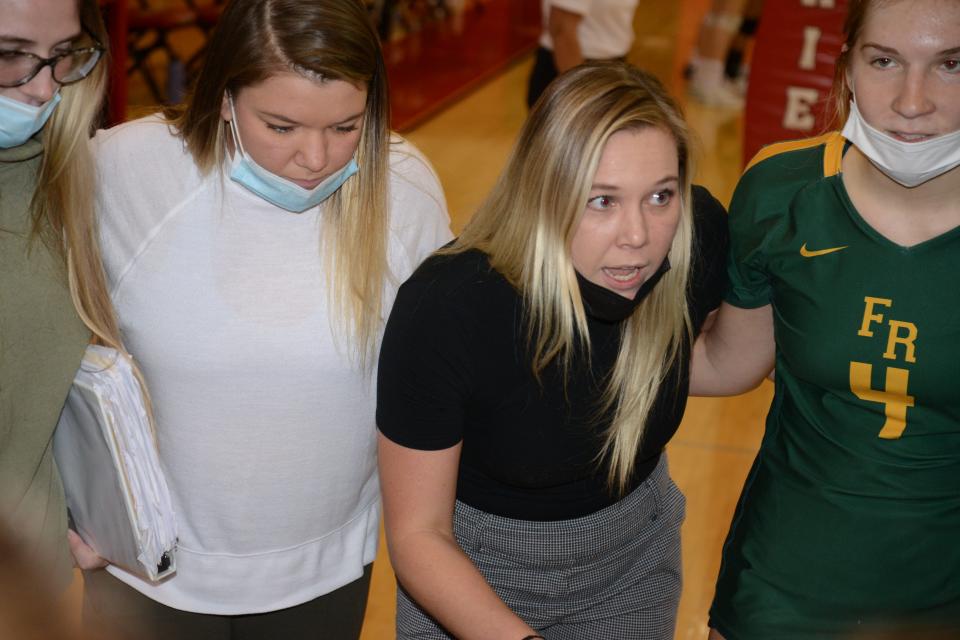 Flat Rock volleyball coach Mackenzie Kaiser makes a point during a timeout with her sister and assistant coach Morgan Kaiser on her right.