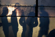 <p>Shadows cast by Palestinians waiting to cross into Egypt through Rafah border crossing between Gaza Strip and Egypt in the southern Gaza Strip, Feb. 7, 2018. (Photo: Mohammed Saber/EPA-EFE/REX/Shutterstock) </p>