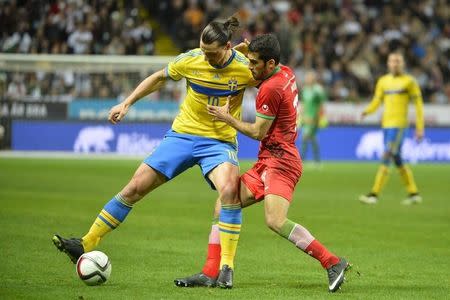 Sweden's Zlatan Ibrahimovic (L) battles Iran's Vahid Amiri during their international friendly soccer match in Stockholm March 31, 2015. REUTERS/Henrik Montgomery/TT News Agency