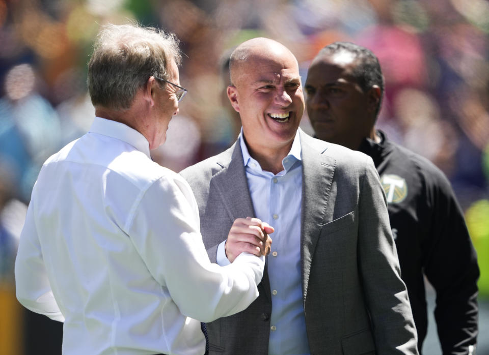 Seattle Sounders head coach Brian Schmetzer, left, greets Portland Timbers head coach Giovanni Savarese before an MLS soccer match Saturday, June 3, 2023, in Seattle. (AP Photo/Lindsey Wasson)