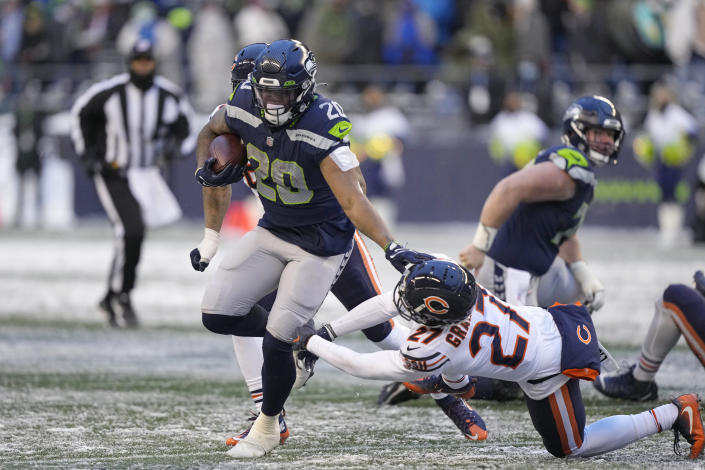 Seattle Seahawks running back Rashaad Penny (20) carries against the Chicago Bears during the second half of an NFL football game, Sunday, Dec. 26, 2021, in Seattle. (AP Photo/Stephen Brashear)