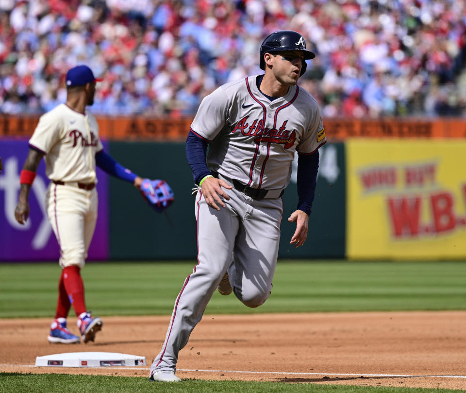 Atlanta Braves' Austin Riley rounds third to score on a single by Adam Duvall during the fourth inning of a baseball game against the Philadelphia Phillies, Sunday, March 31, 2024, in Philadelphia. (AP Photo/Derik Hamilton)