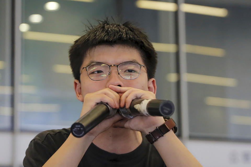 FILE - In this June 17, 2019, file photo, pro-democracy activist Joshua Wong speaks to protesters near the Legislative Council following a massive protest against the unpopular extradition bill in Hong Kong. Demosisto, a pro-democracy group in Hong Kong posted on its social media accounts that well-known activist Joshua Wong had been pushed into a private car around 7:30 a.m. Friday, Aug. 30, 2019 and was taken to police headquarters. It later said another member, Agnes Chow, had been arrested as well. (AP Photo/Kin Cheung, File)