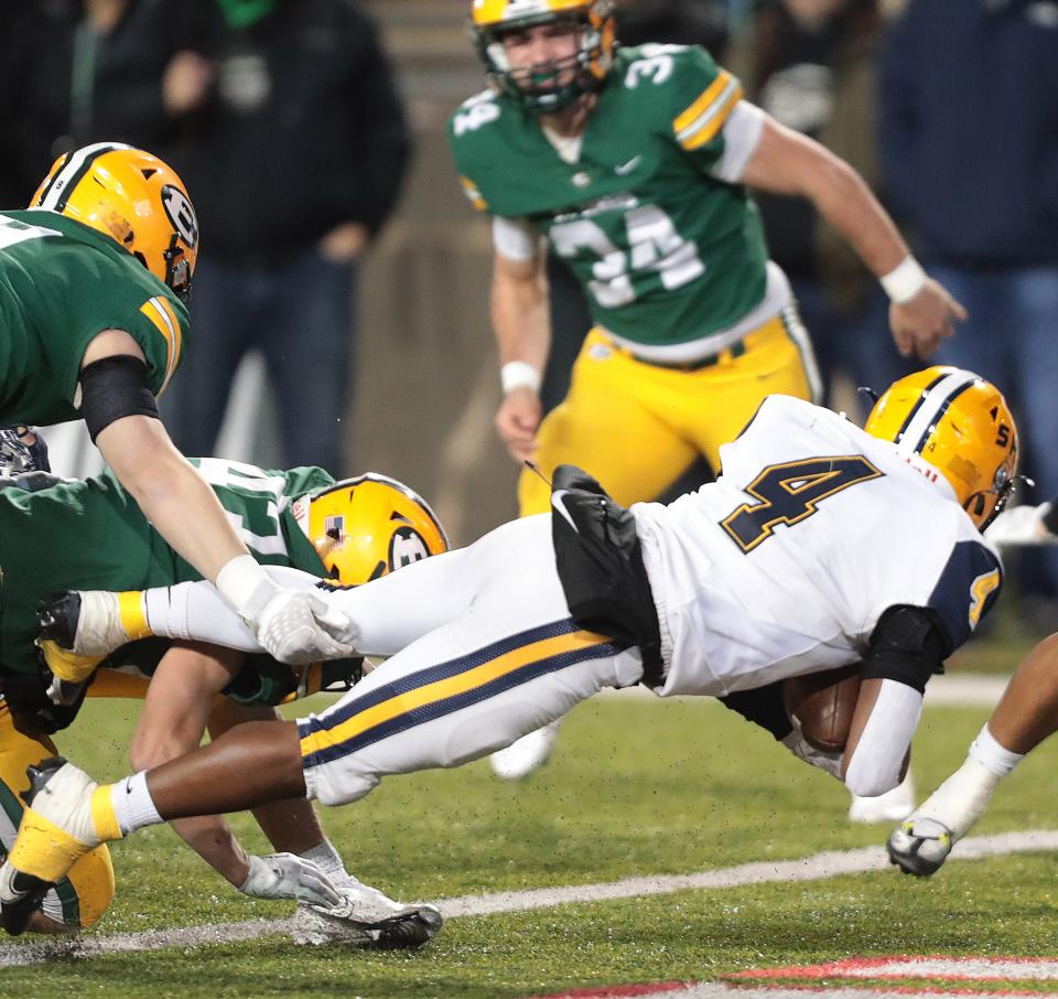 Springfield's Jayvin Norman dives into the end zone for a first-half touchdown against St. Edward during the Division I state championship game at Tom Benson Hall of Fame Stadium in Canton, Friday, Dec. 2, 2022.