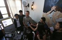 (Top L-R) Tembusu Terminals' partners Peter Peh Sik Wee, Jarrod Luo and Andras Kristof speak to the media after launching the first Bitcoin vending machine at a pub in Singapore February 27, 2014. According to Tembusu Terminals, this is the first Bitcoin vending machine in Asia. REUTERS/Edgar Su