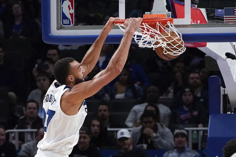 Minnesota Timberwolves center Rudy Gobert (27) dunks against the Detroit Pistons in the first half of an NBA basketball game in Detroit, Wednesday, Jan. 11, 2023. (AP Photo/Paul Sancya)