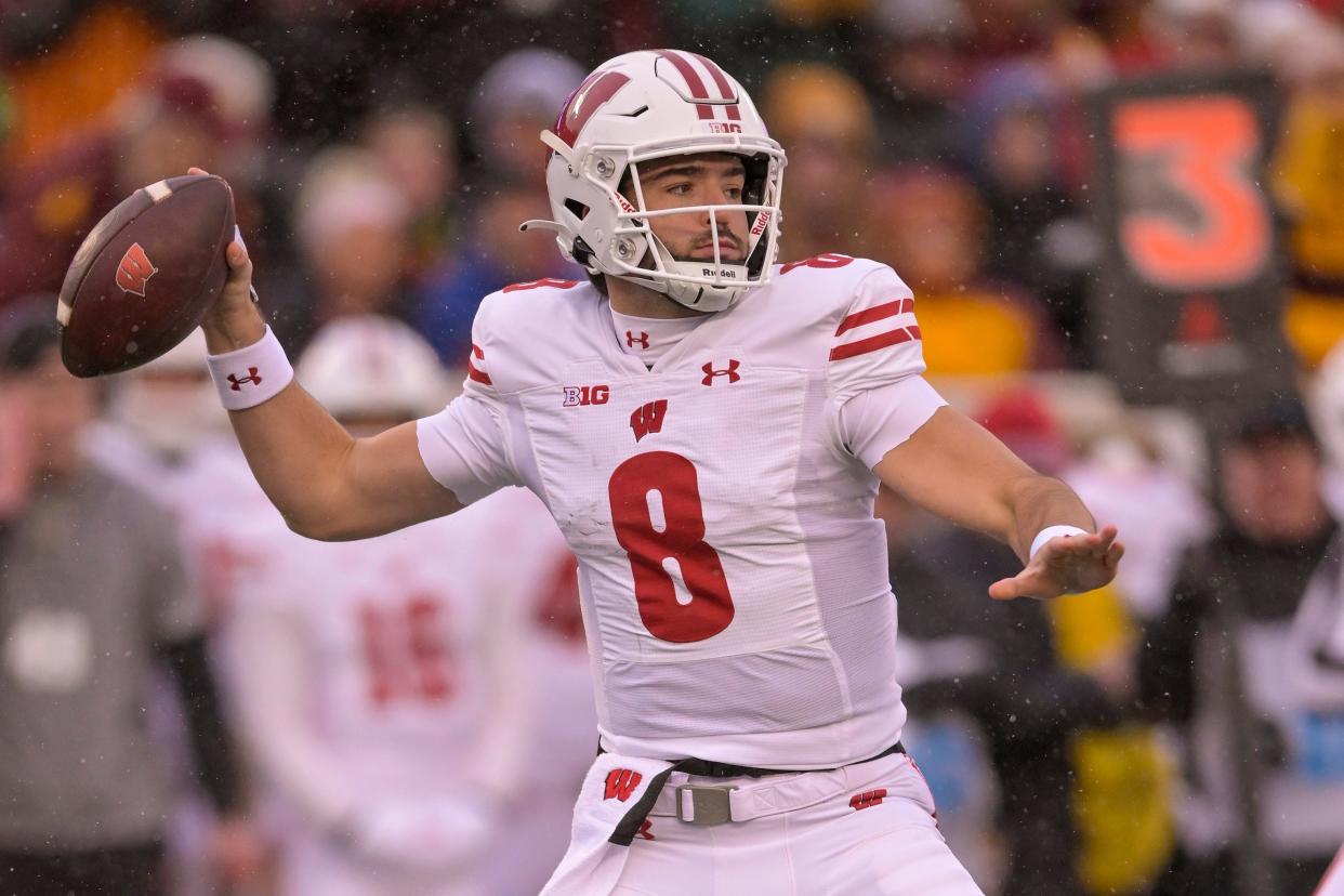 Nov 25, 2023; Minneapolis, Minnesota, USA; Wisconsin Badgers quarterback Tanner Mordecai (8) makes a pass against the Minnesota Golden Gophers during the first quarter at Huntington Bank Stadium. Mandatory Credit: Nick Wosika-USA TODAY Sports