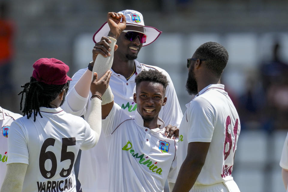 West Indies' Alick Athanaze celebrates with teammates the dismissal of India's captain Rohit Sharma for 103 runs on day two of their first cricket Test match at Windsor Park in Roseau, Dominica, Thursday, July 13, 2023. (AP Photo/Ricardo Mazalan)