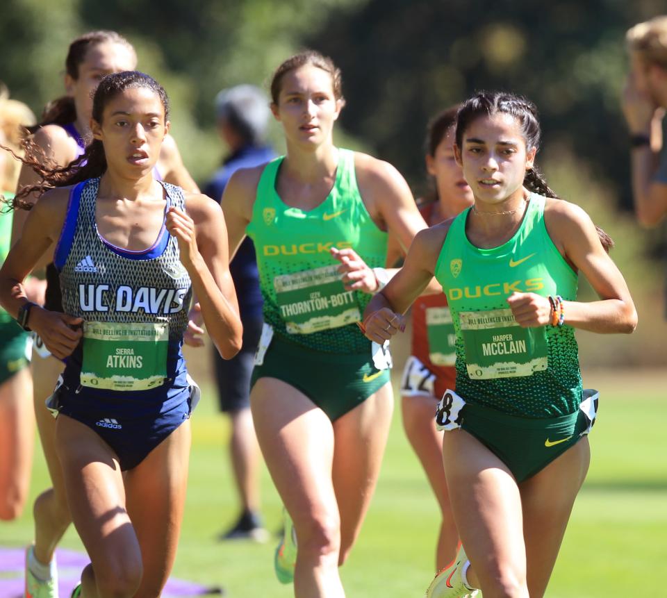 Eventual winner Sierra Atkins from UC Davis, left, runs with Oregon's Izzy Thornton-Bott, center, and Harper McClain, right, during Friday's 2022 Bill Dellinger Invitational at Pine Ridge Golf Club in Springfield.