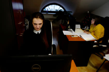 Town hall clerk Monika Pawlik, 24, works at her office in City Hall in Ostrow Mazowiecka, Poland, January 16, 2018. REUTERS/Kacper Pempel/Files