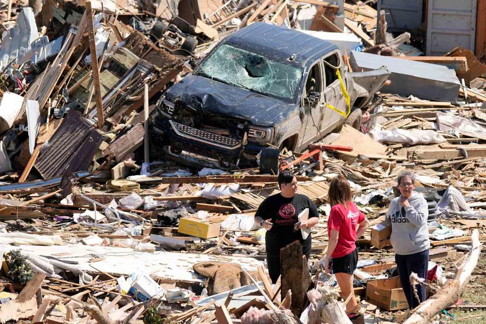 <p>AP Photo/Charlie Neibergall</p> Locals survey damage from the tornado that ripped through Greenfield, Iowa on Tuesday, May 21