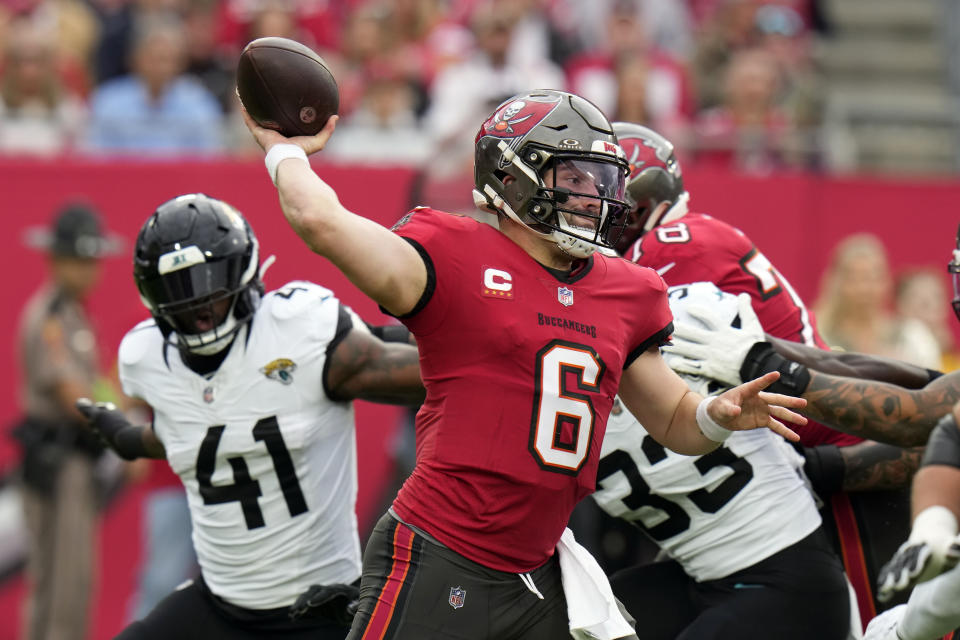 Tampa Bay Buccaneers quarterback Baker Mayfield (6) throws a pass as he is pressured by Jacksonville Jaguars linebacker Josh Allen (41) during the first half of an NFL football game Sunday, Dec. 24, 2023, in Tampa, Fla. (AP Photo/Chris O'Meara)