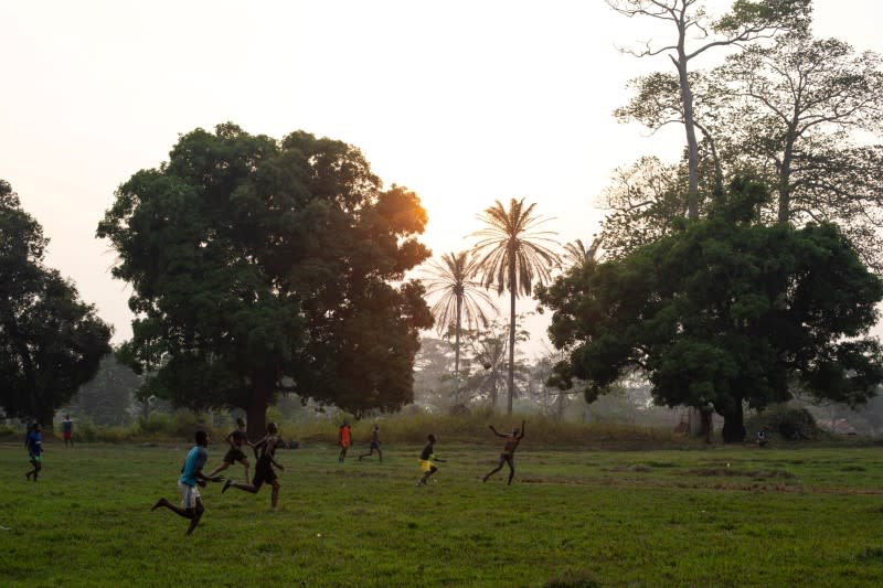 Young men play soccer in the town of Boso-Manzi in Mongala province