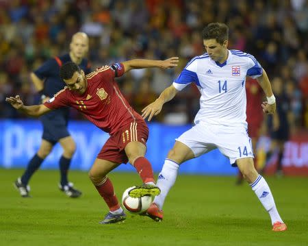 Spain's Pedro Rodriguez (L) fights for the ball with Luxembourg's Kevin Malget during their Euro 2016 Group C qualification soccer match in Logrono, Spain October 9, 2015. REUTERS/Vincent West